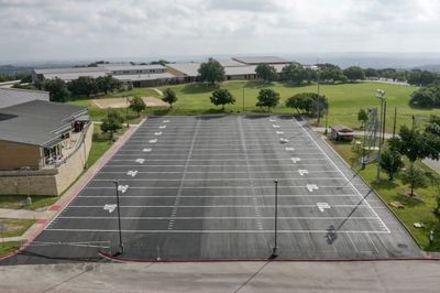 Aerial view of parking lot marked to replicate a football field.