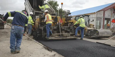 Stripe-It-Up crew applies fresh asphalt paving.