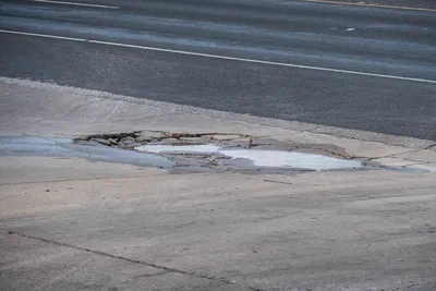 Concrete damage with pothole and water in Georgetown, TX