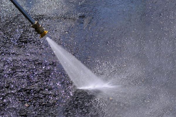 Power washers can be an effective method for cleaning asphalt and concrete surfaces