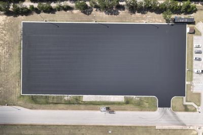 Aerial view of a freshly sealcoated parking lot