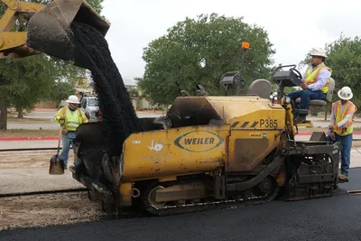 Asphalt is applied to a new parking lot